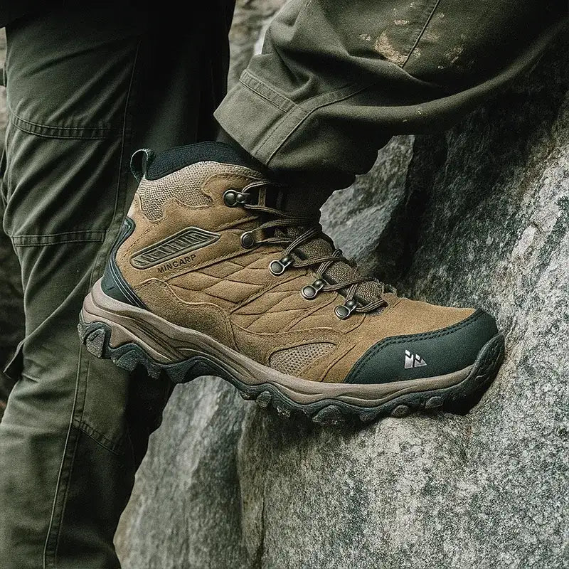 Tan and dark green hiking boot with quilted suede upper, mesh panels, and rugged rubber sole.